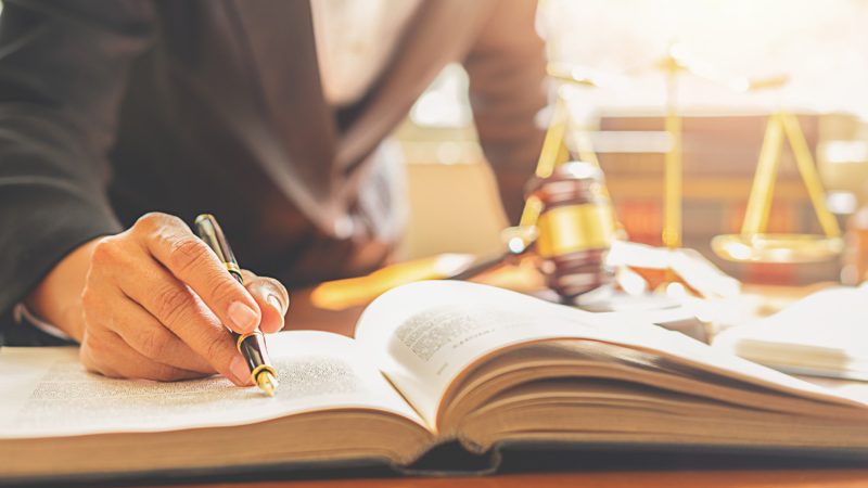 judge-gavel-with-justice-lawyers-having-team-meeting-law-firm-background